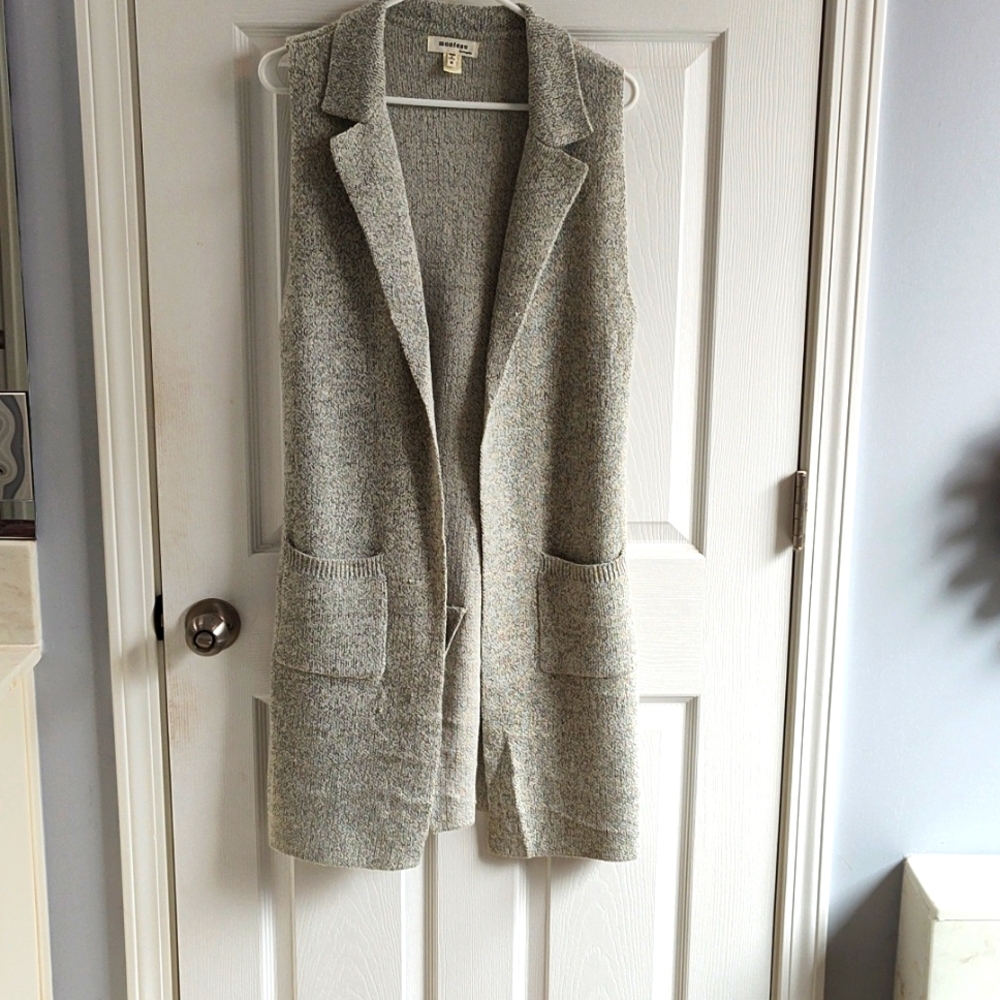 Knee length, sleeveless cardigan style jacket. Monteau size medium.